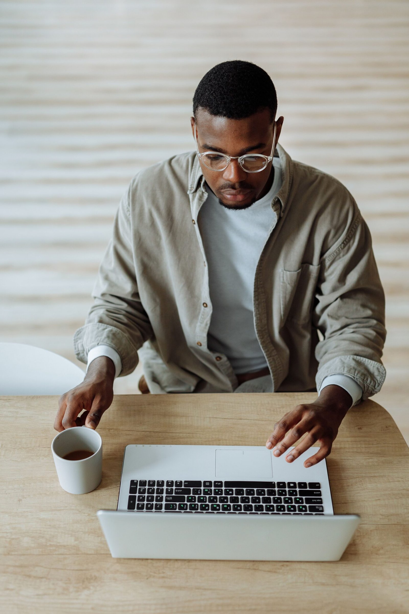 A person working at a laptop in a calm home setting
